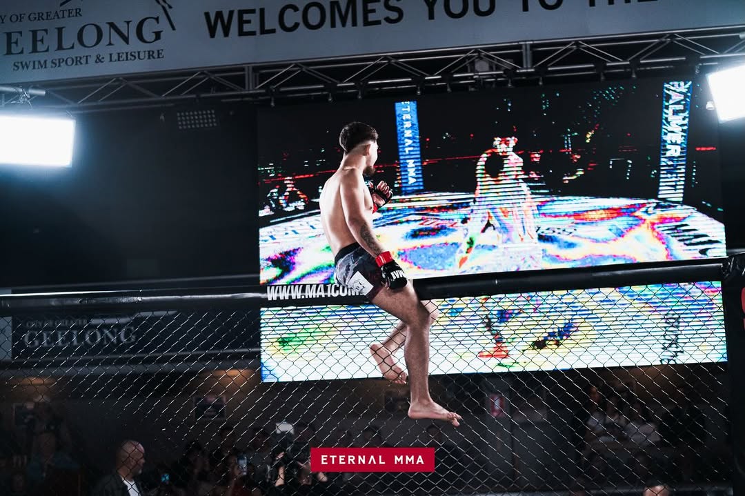 Kourosh Arvan climbs the cage after the knockout